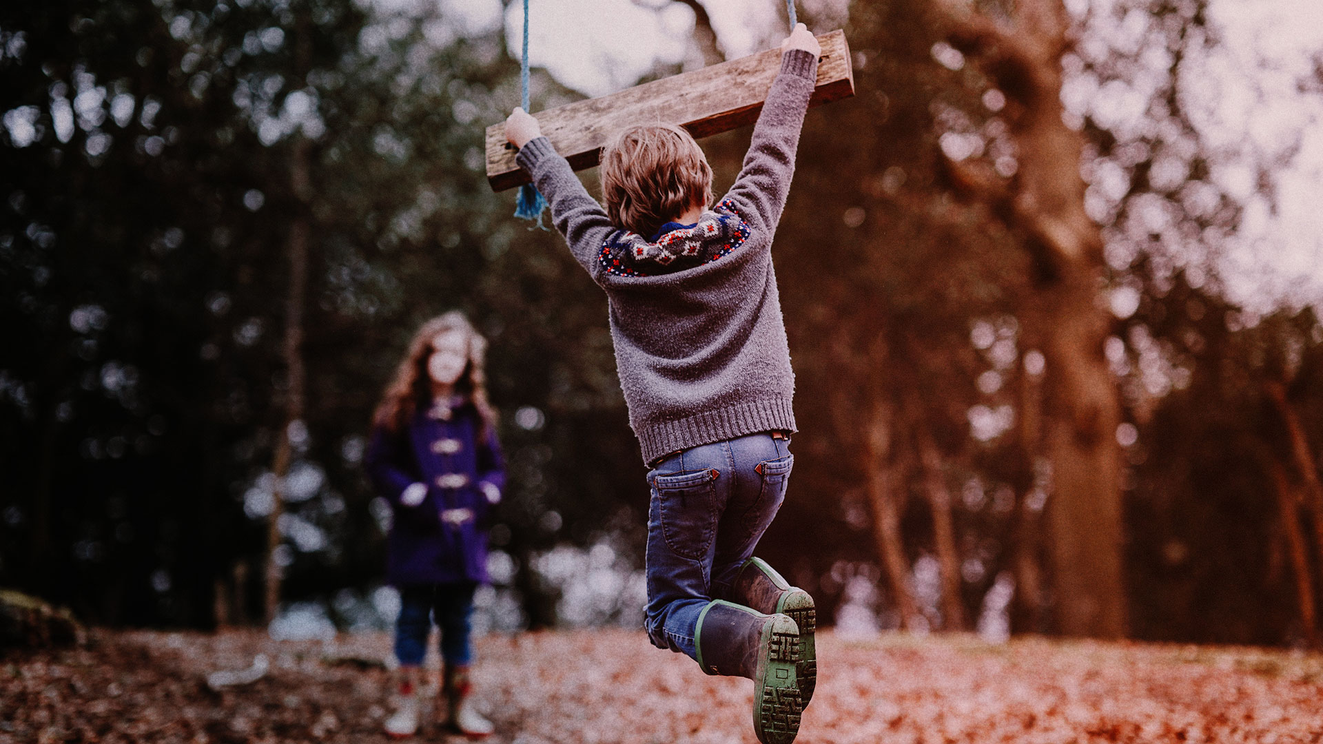 Two children playing in forest