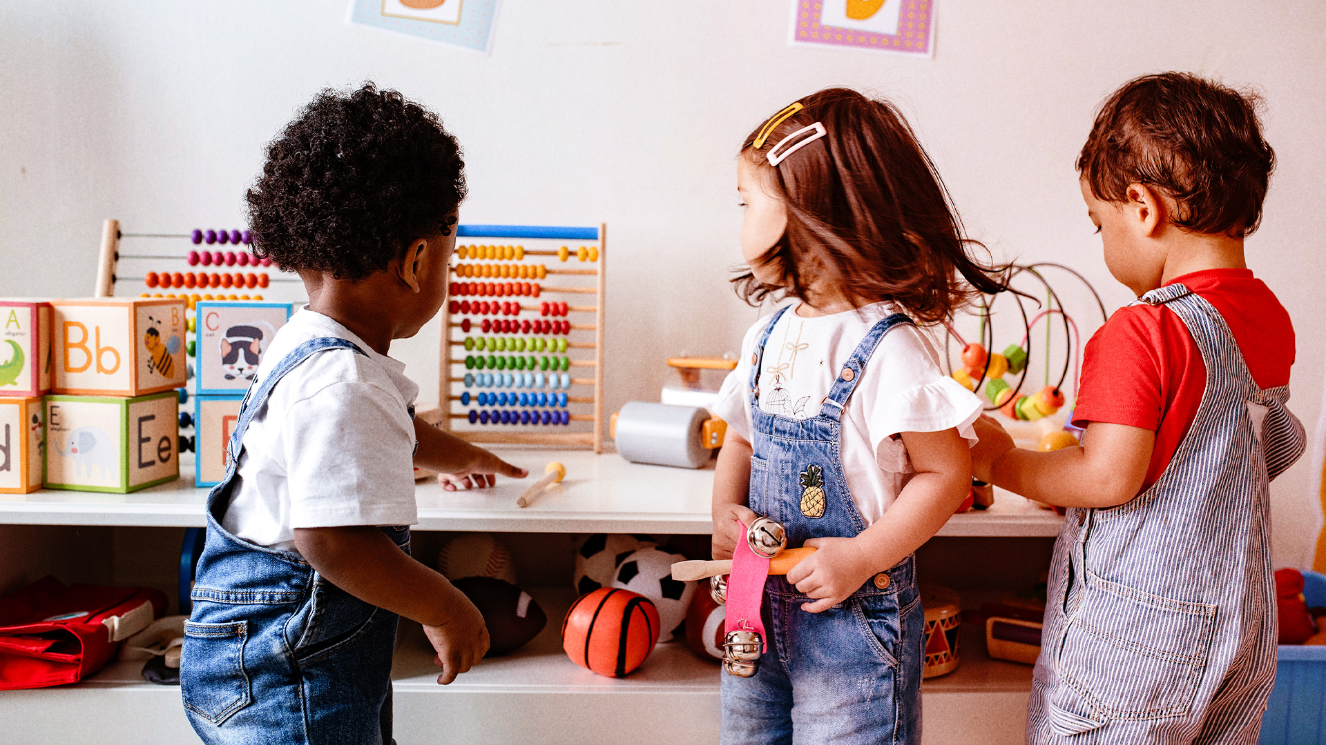 Three children playing with toys