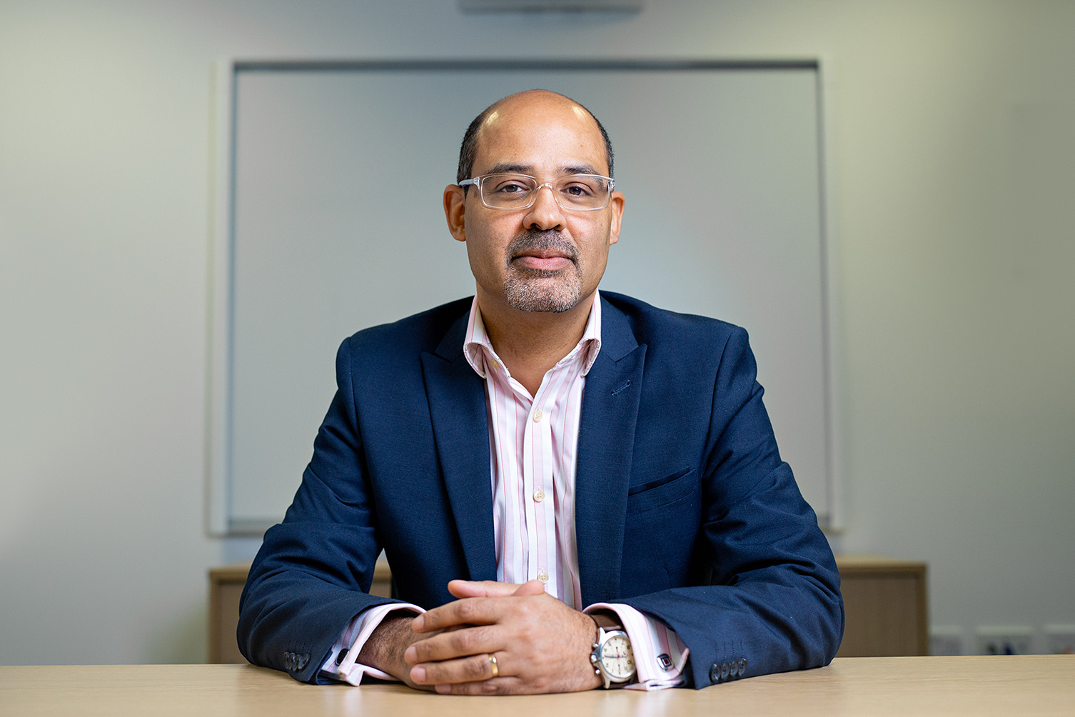 Chris Hughes sitting at desk 